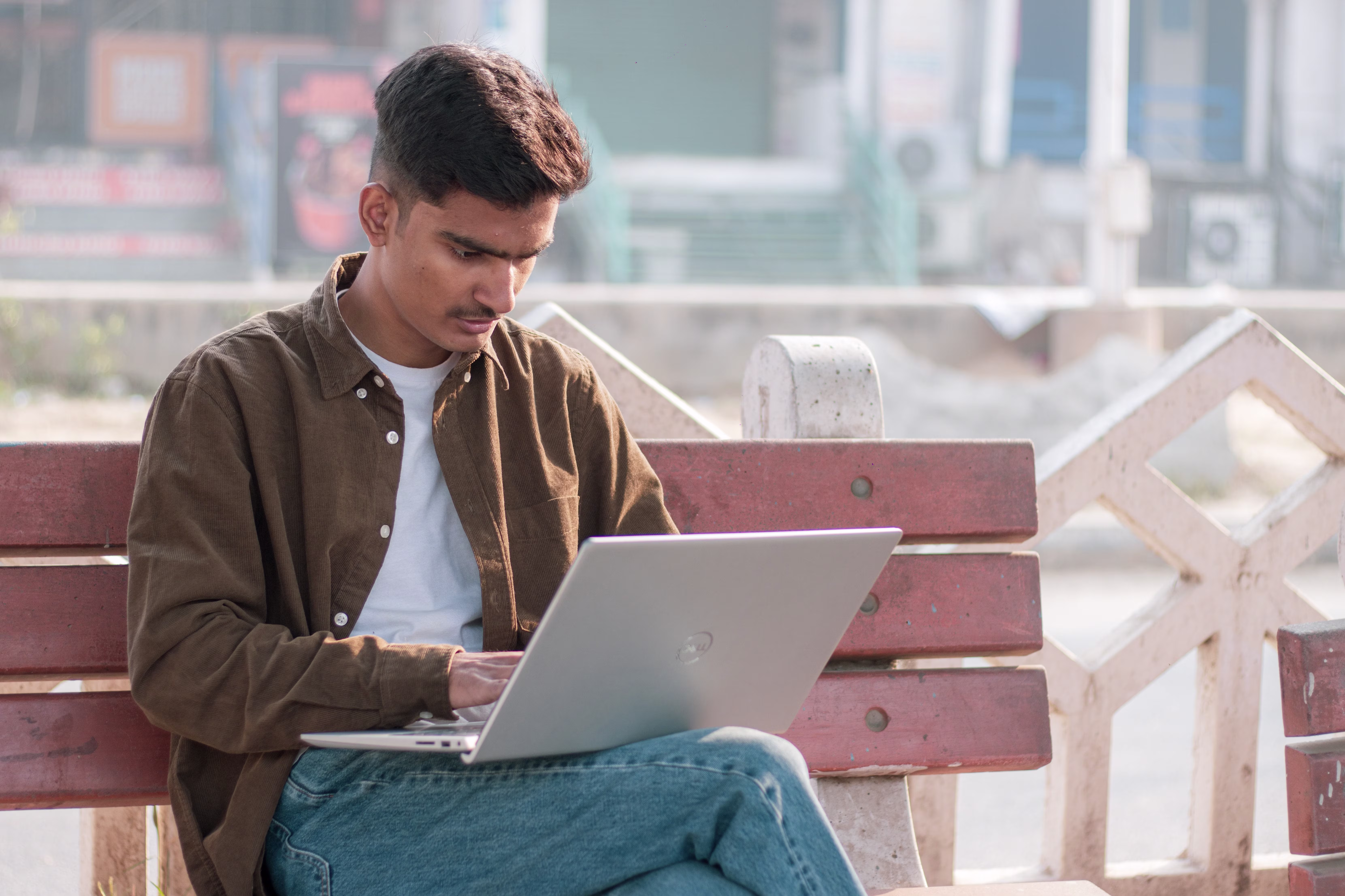 A young boy studying on a laptop