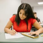 Student in a red top taking an exam