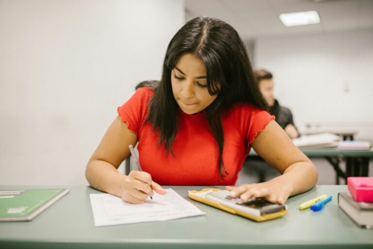 Student in a red top taking an exam